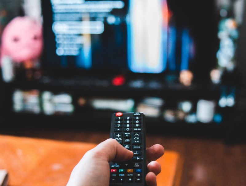 A Person Holding a Remote Toward the TV